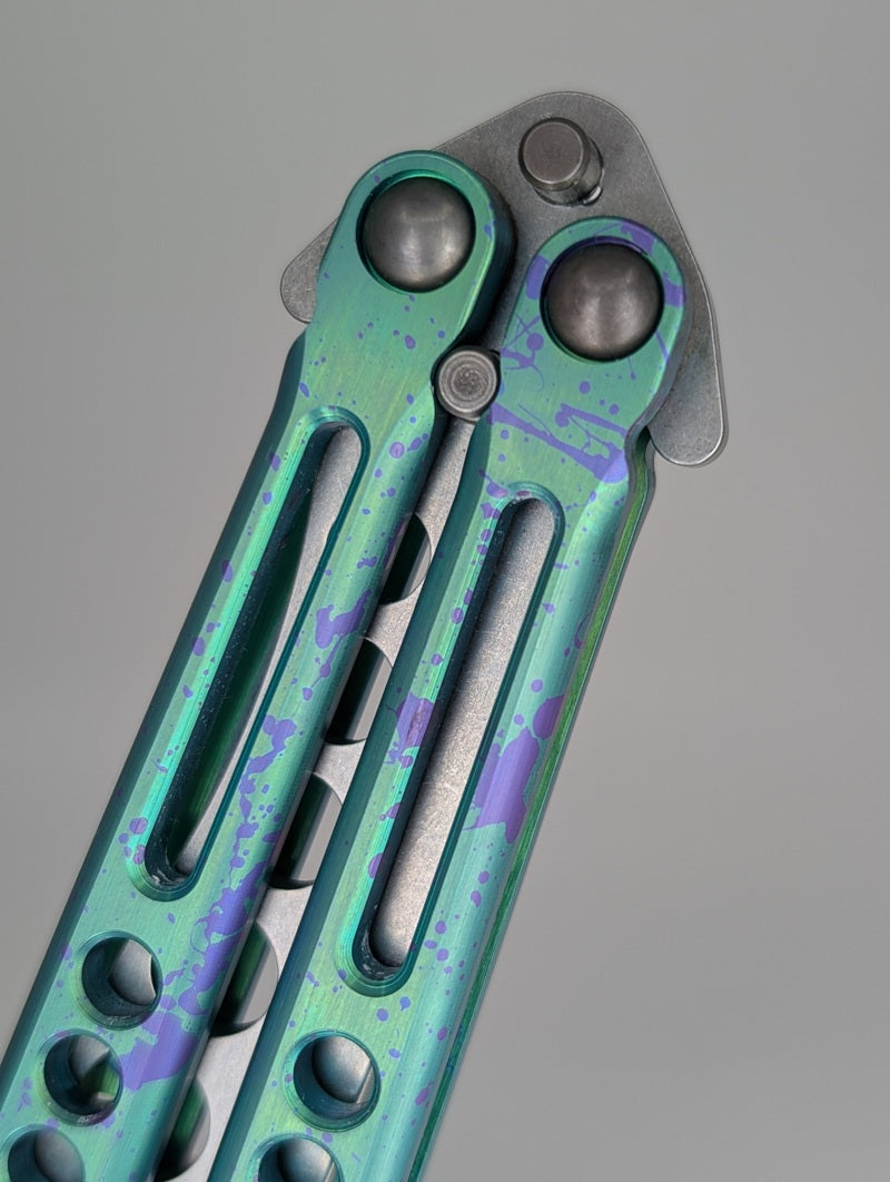 HOM Design Prodigy Titanium Green w/ Purple Splatter Balisong Trainer Mod. C