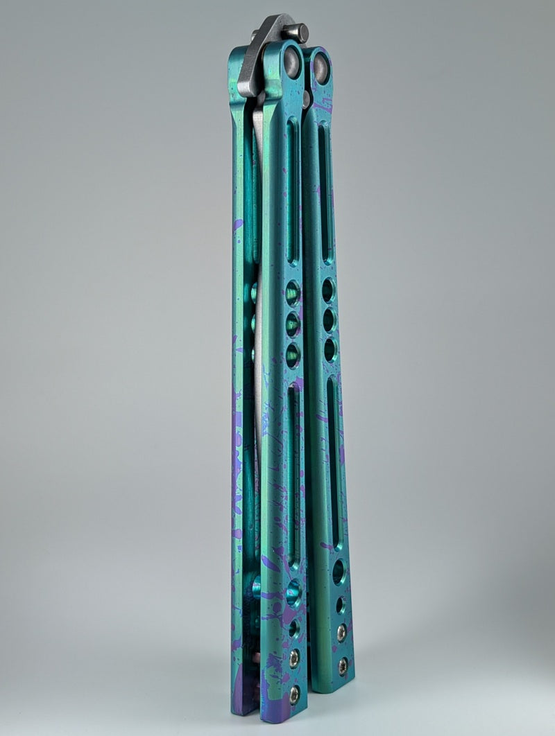 HOM Design Prodigy Titanium Green w/ Purple Splatter Balisong Trainer Mod. C