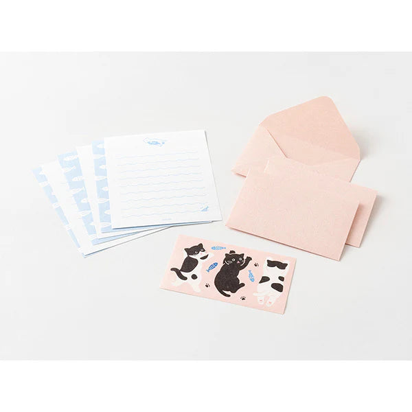Set of stationery items including a pink envelope, cards with cat illustrations, and a small notebook on a white background.