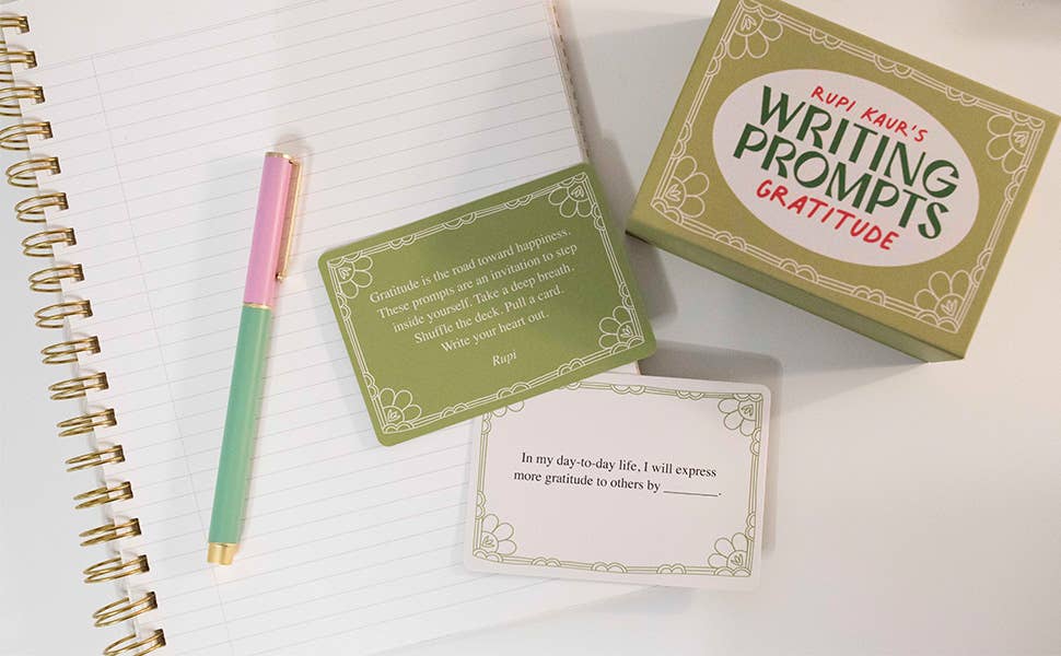 Rupi Kaur’s Writing Prompts: cards with a pen on a notebook
