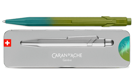 Caran d'Ache Arctic Green and Grey pen with a gradient design and its packaging on a black background