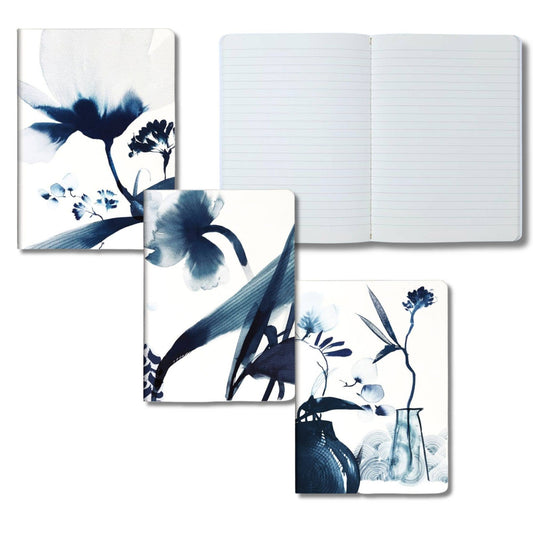 Floral design notebooks and a journal on a white background