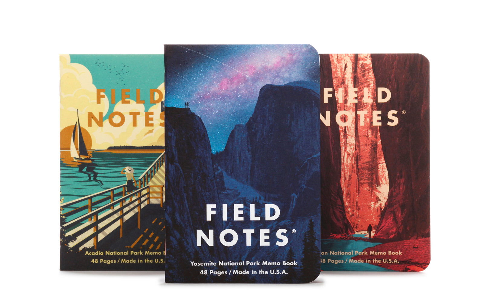 A set of three Field Notes memo books with illustrations of Yosemite, Acadia, and Zion national parks on the covers.