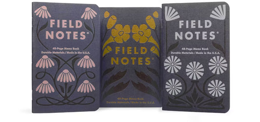 Three Field Notes notebooks with floral designs on a white background