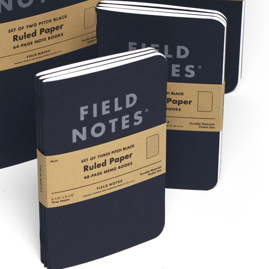 Field Notes notebooks with brown labels on a white background