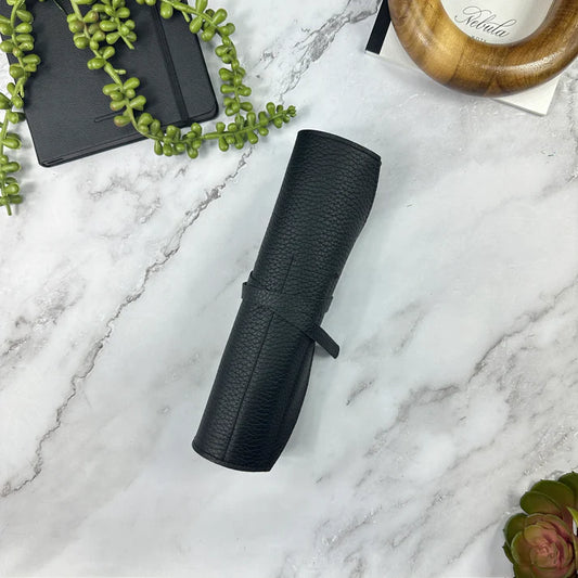 Black textured roll on a marble surface with decorative elements.