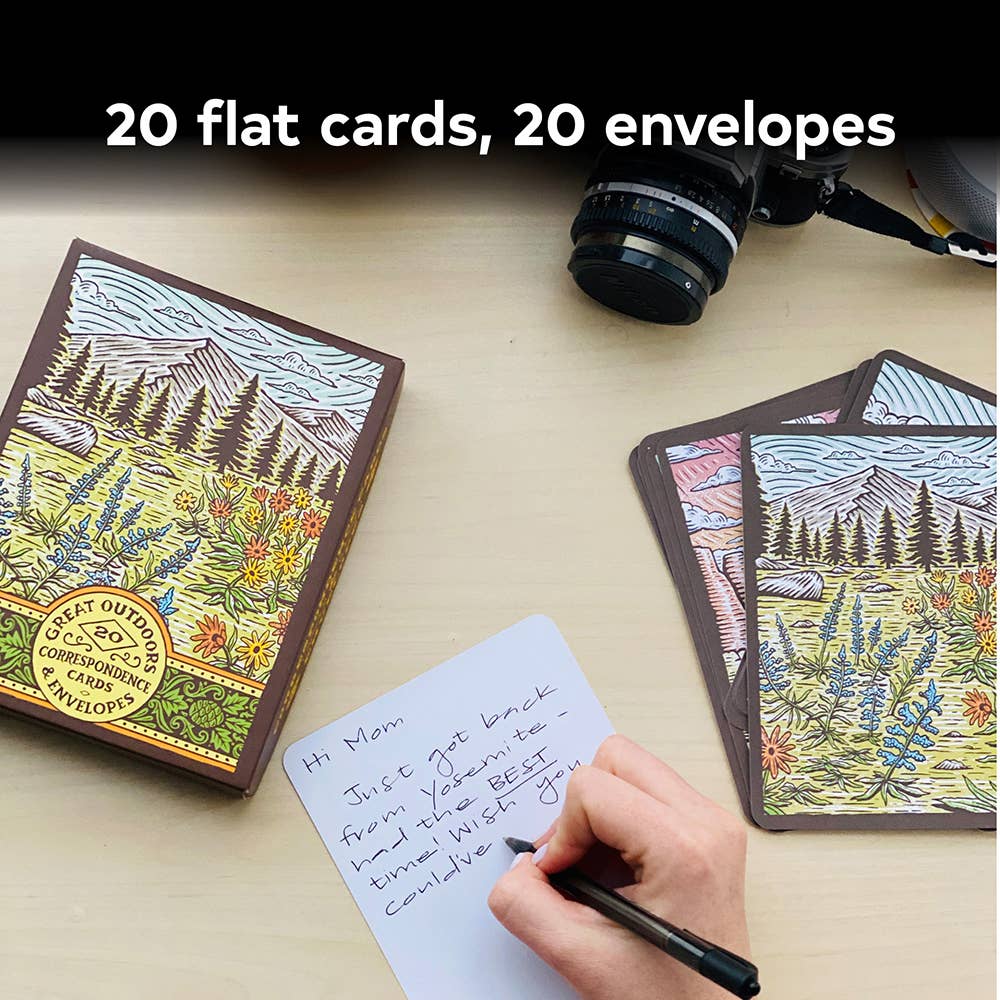 Handwritten letter with nature-themed cards and envelopes on a table.