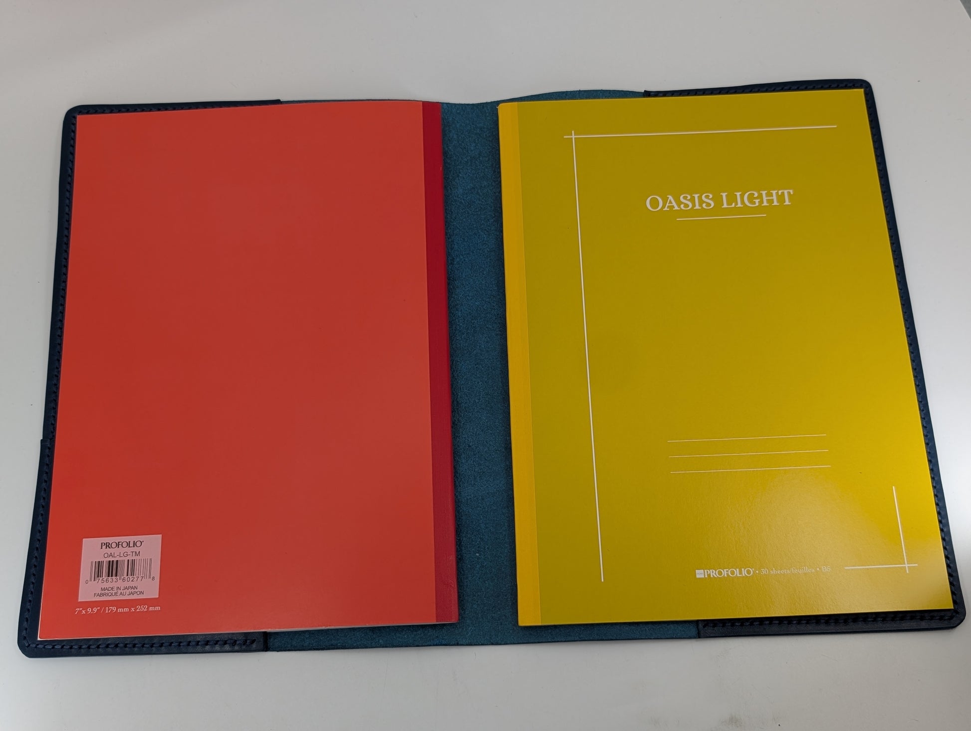 Open notebook with red and yellow pages on a white background