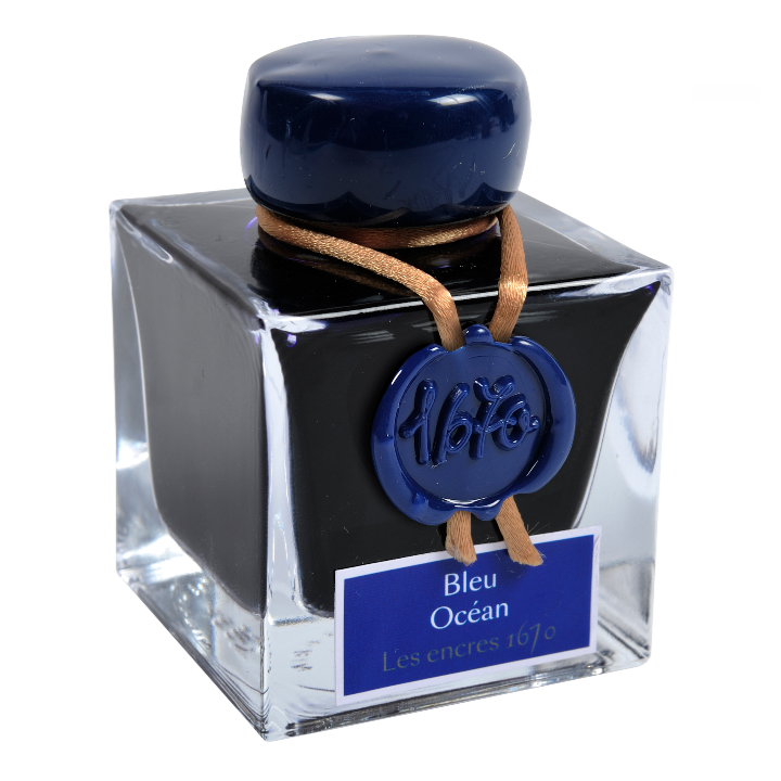 Ink bottle with blue cap and label on a white background