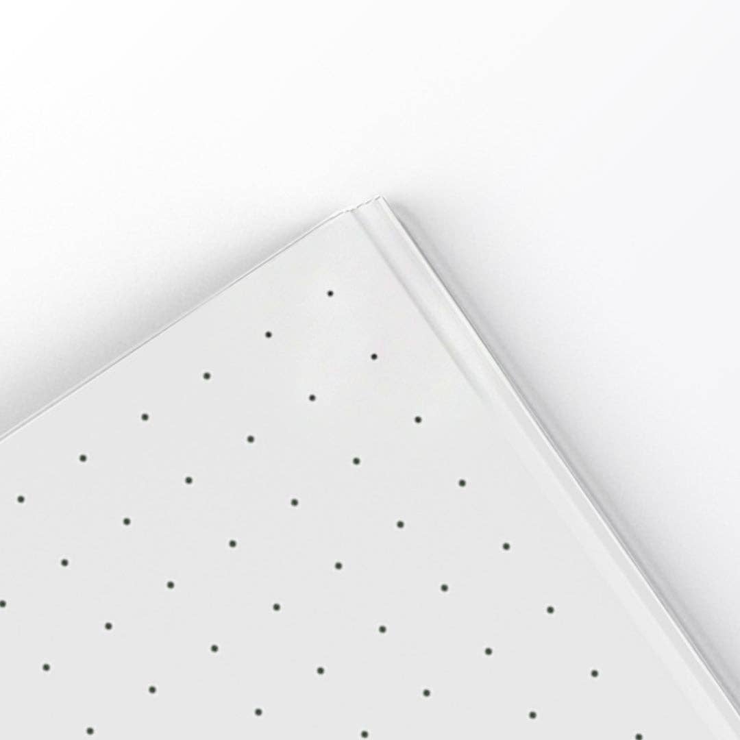 White paper with black polka dots on a white background