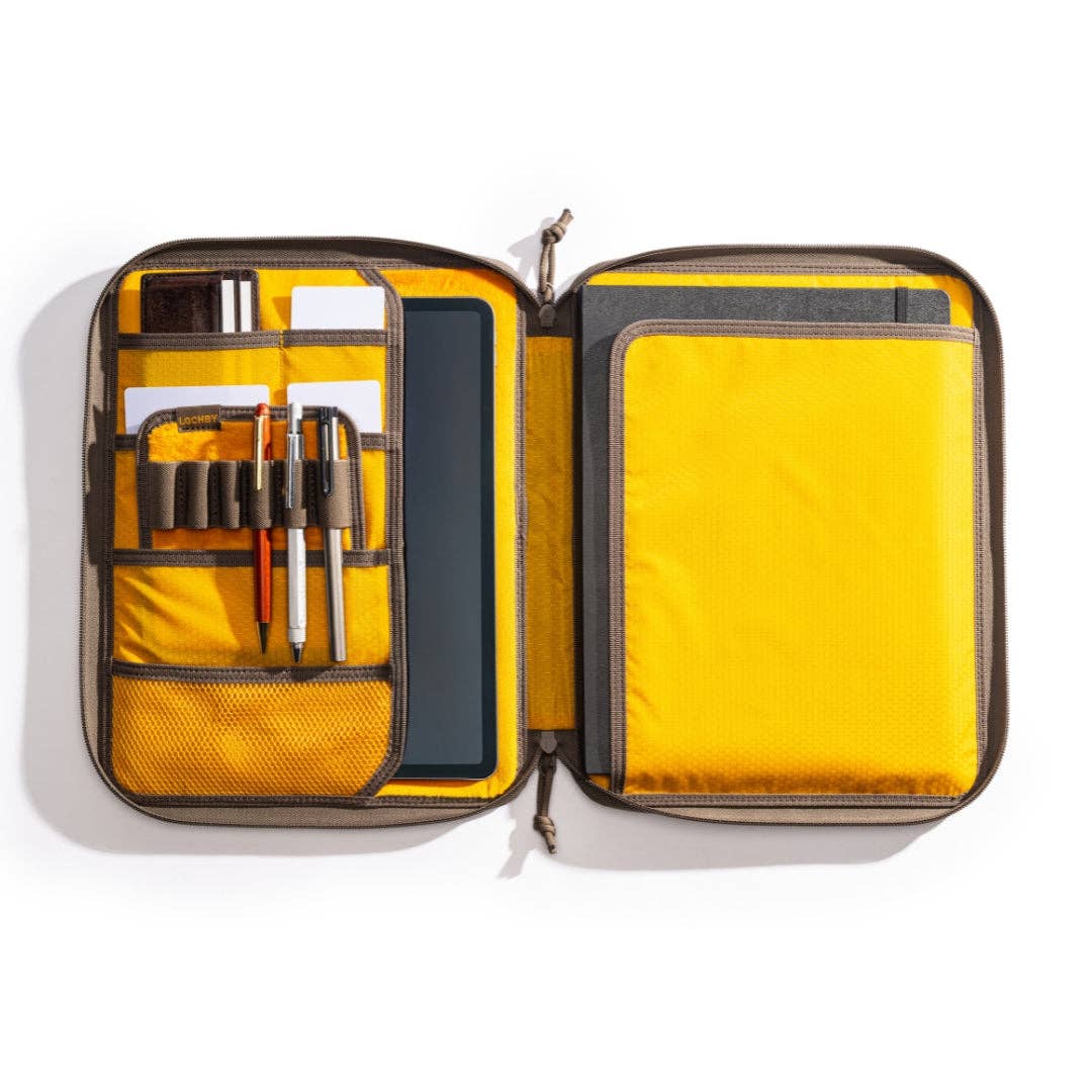 LOCHBY Daily Folio A4 open zippered notebook and tablet organizer case with a bright yellow interior, dark gray exterior trim, and various stationery items stored in elastic pockets, shown on a white background.