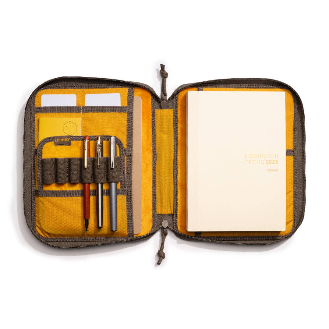 Open LOCHBY Daily Folio A5 with pens and a notebook on a white background