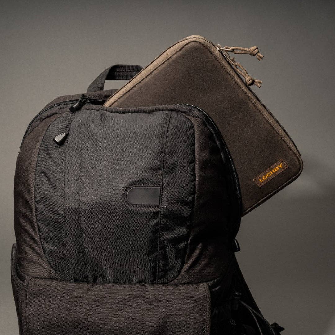 Black backpack with a brown pouch on a gray background