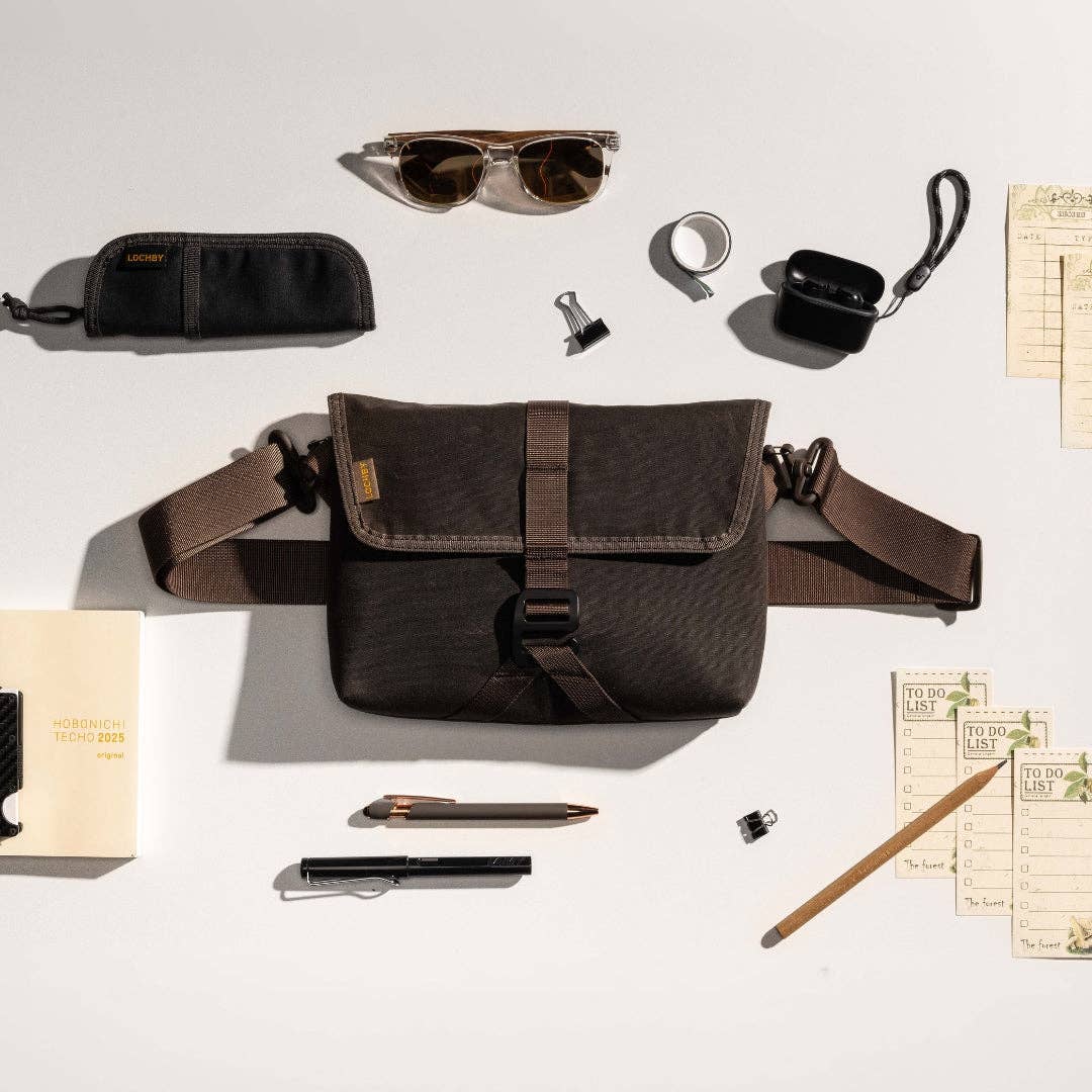 Brown LOCHBY bag with accessories on a white background