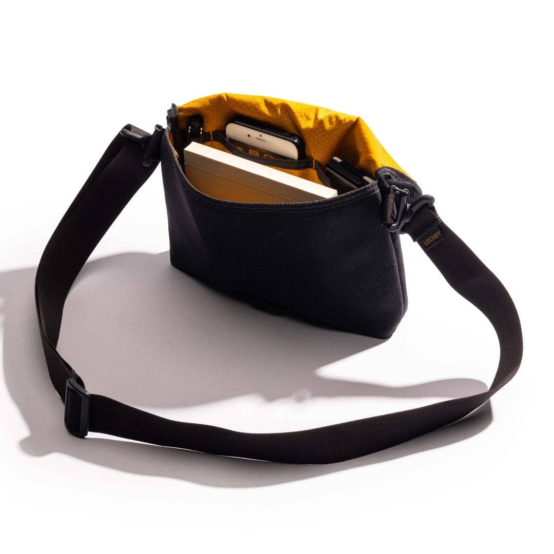 Black and yellow LOCHBY bag with a strap on a white background