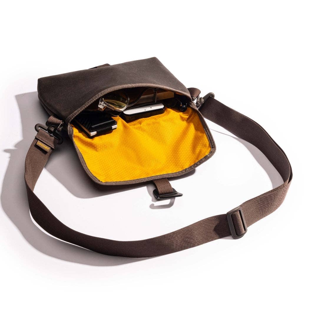 Brown LOCHBY bag with yellow interior on a white background