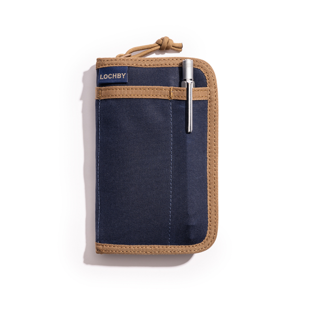 Navy pouch with brown trim and pen, featuring Lochby branding, on a white background