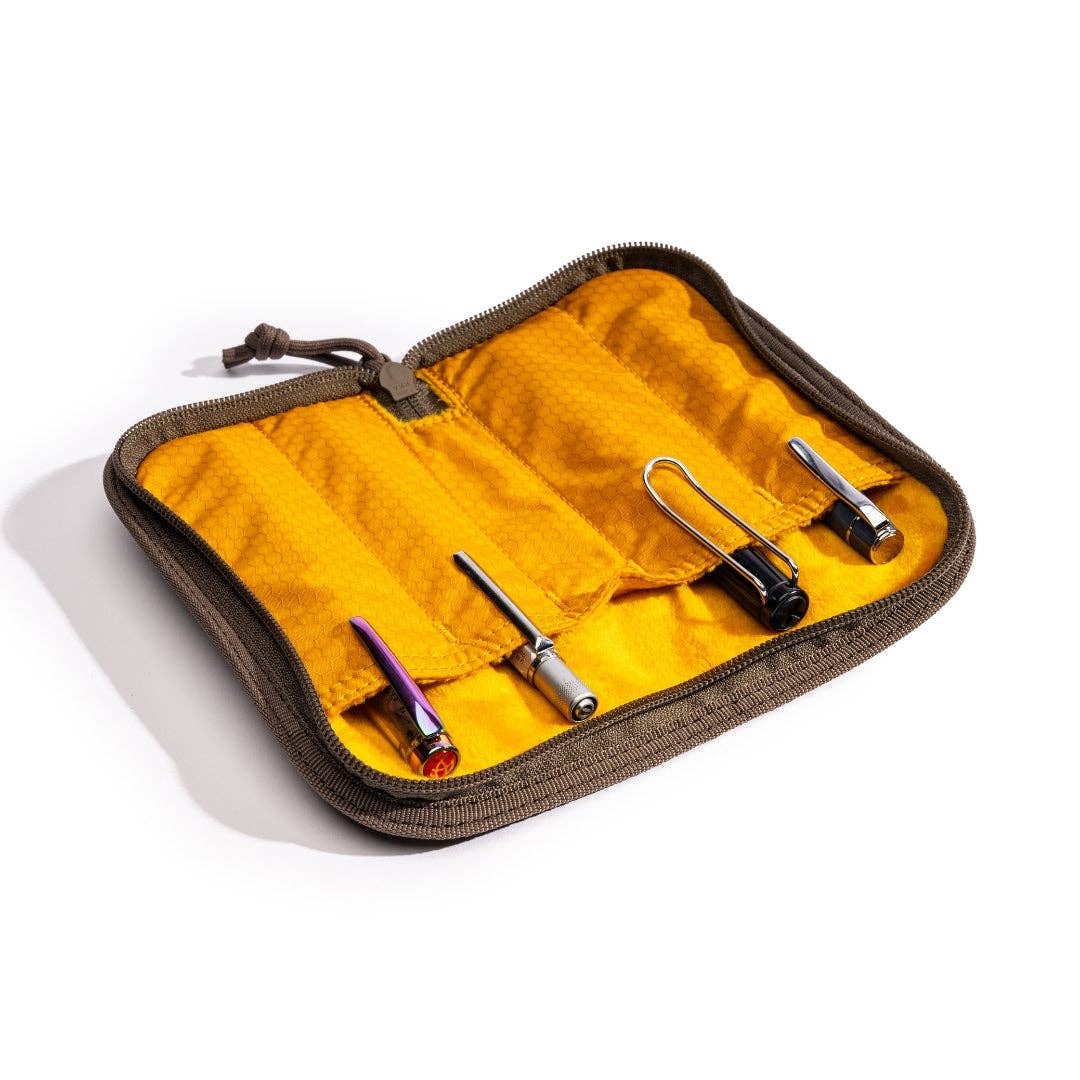 LOCHBY Quattro  case with yellow interior containing various pens on a white background
