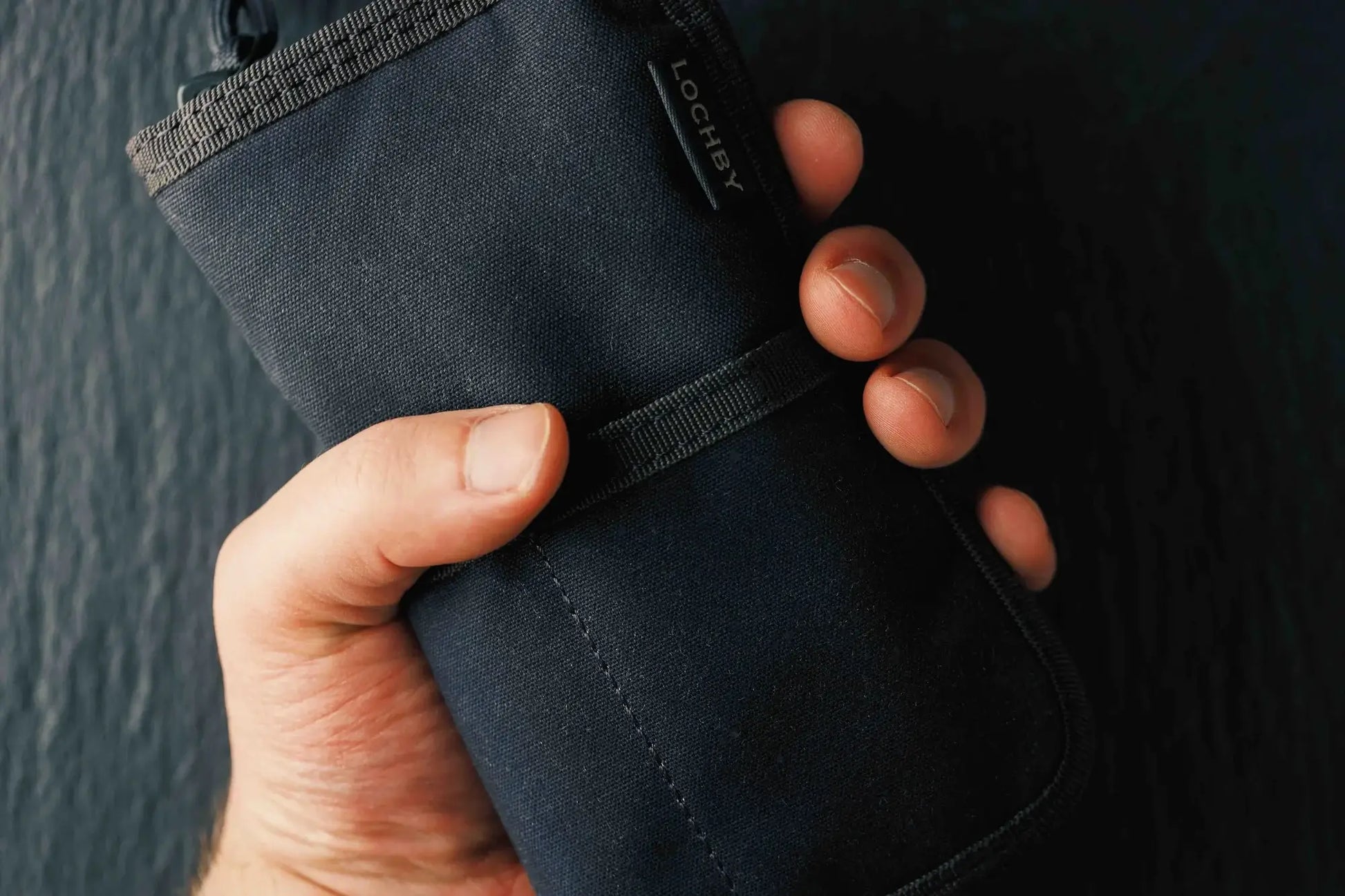 Hand holding a Lochby Quattro Pen Holder in black