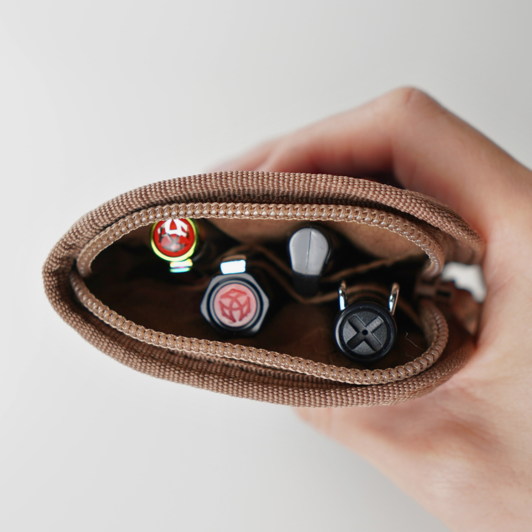 Lochby Quattro Pen Holder in Hand holding a case with pen accessories on a light gray background