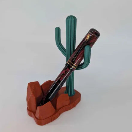 Pen in a cactus-shaped holder on a white background