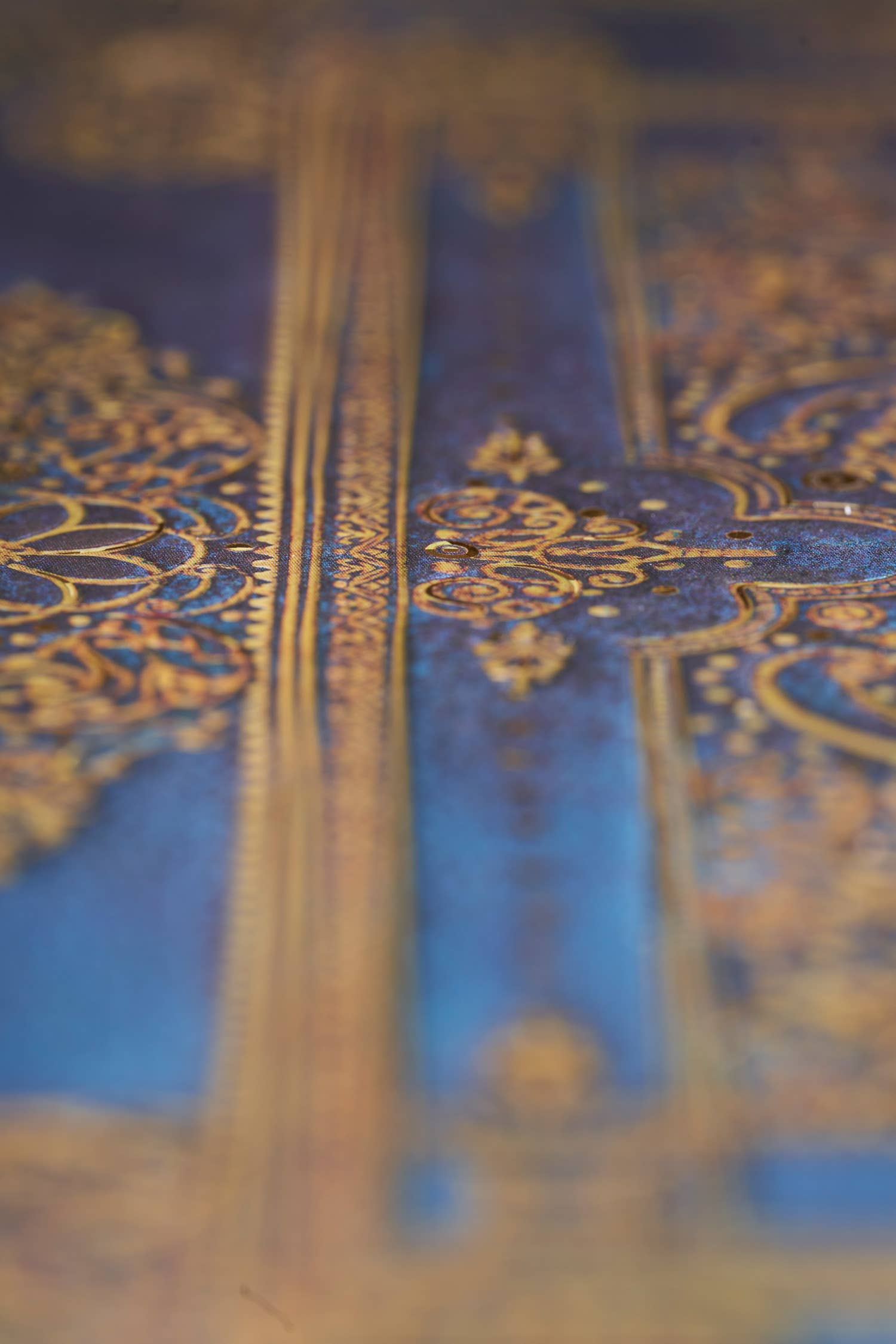 Close-up of a blue book with gold embroidery