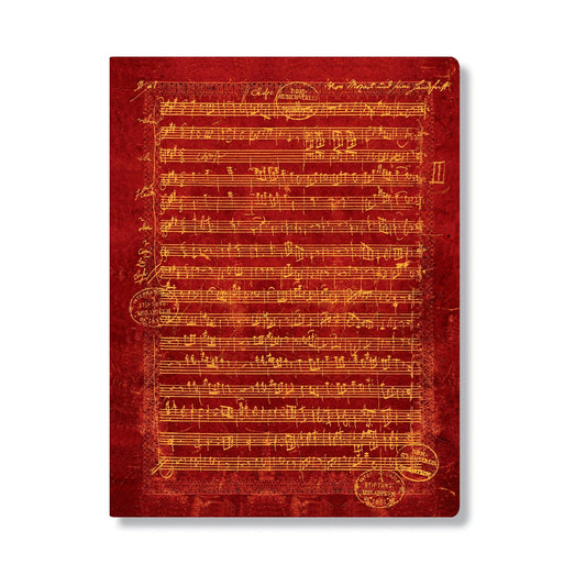 Red notebook with music sheet design on a white background