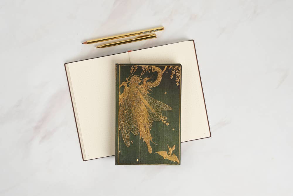 Open notebook with a gold fairy illustration on a white background