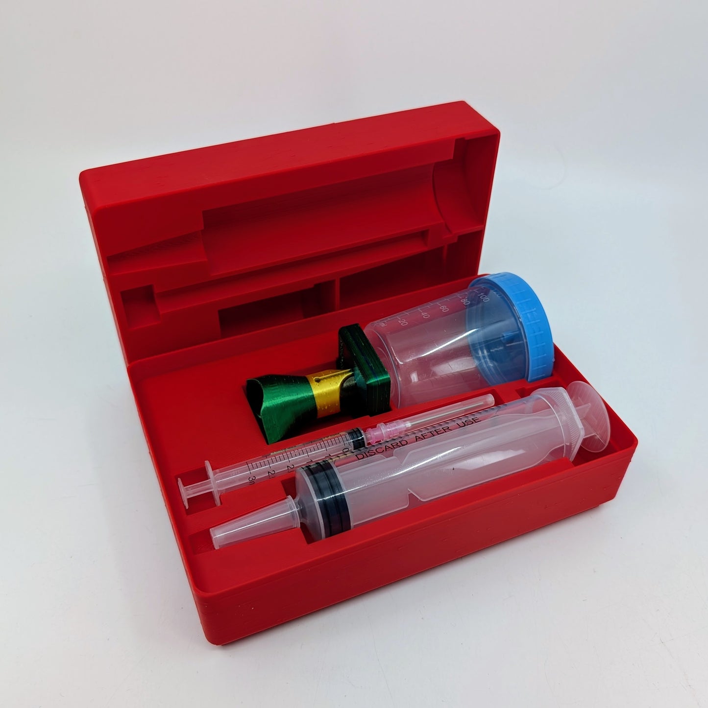 Penchetta Red pen maintenance kit with syringe and other components on a white background