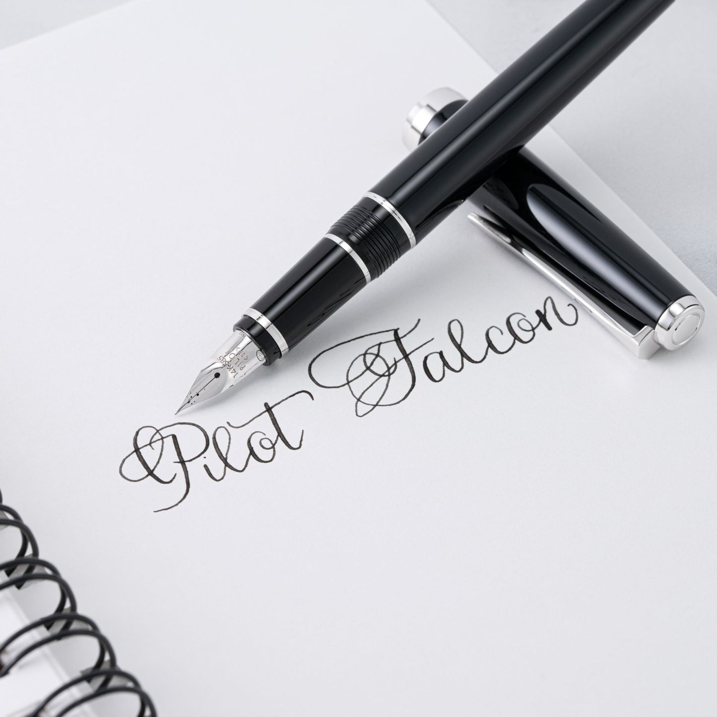 Pilot Falcon fountain pen on a notebook with visible branding
