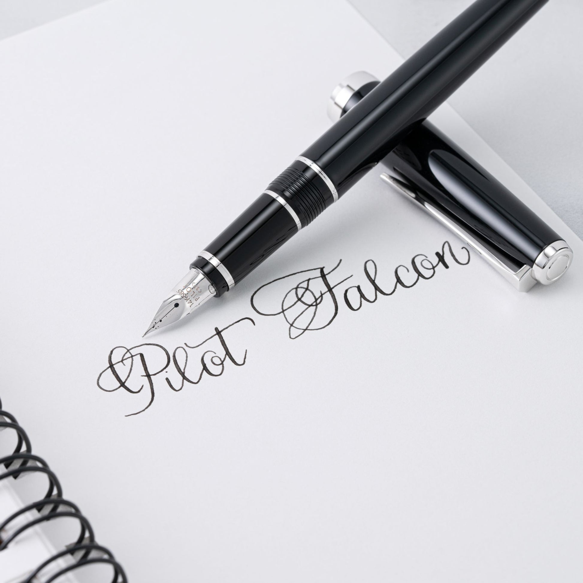 Pilot Falcon fountain pen on a notebook with visible branding