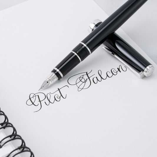 Pilot Falcon fountain pen on a notebook with visible branding