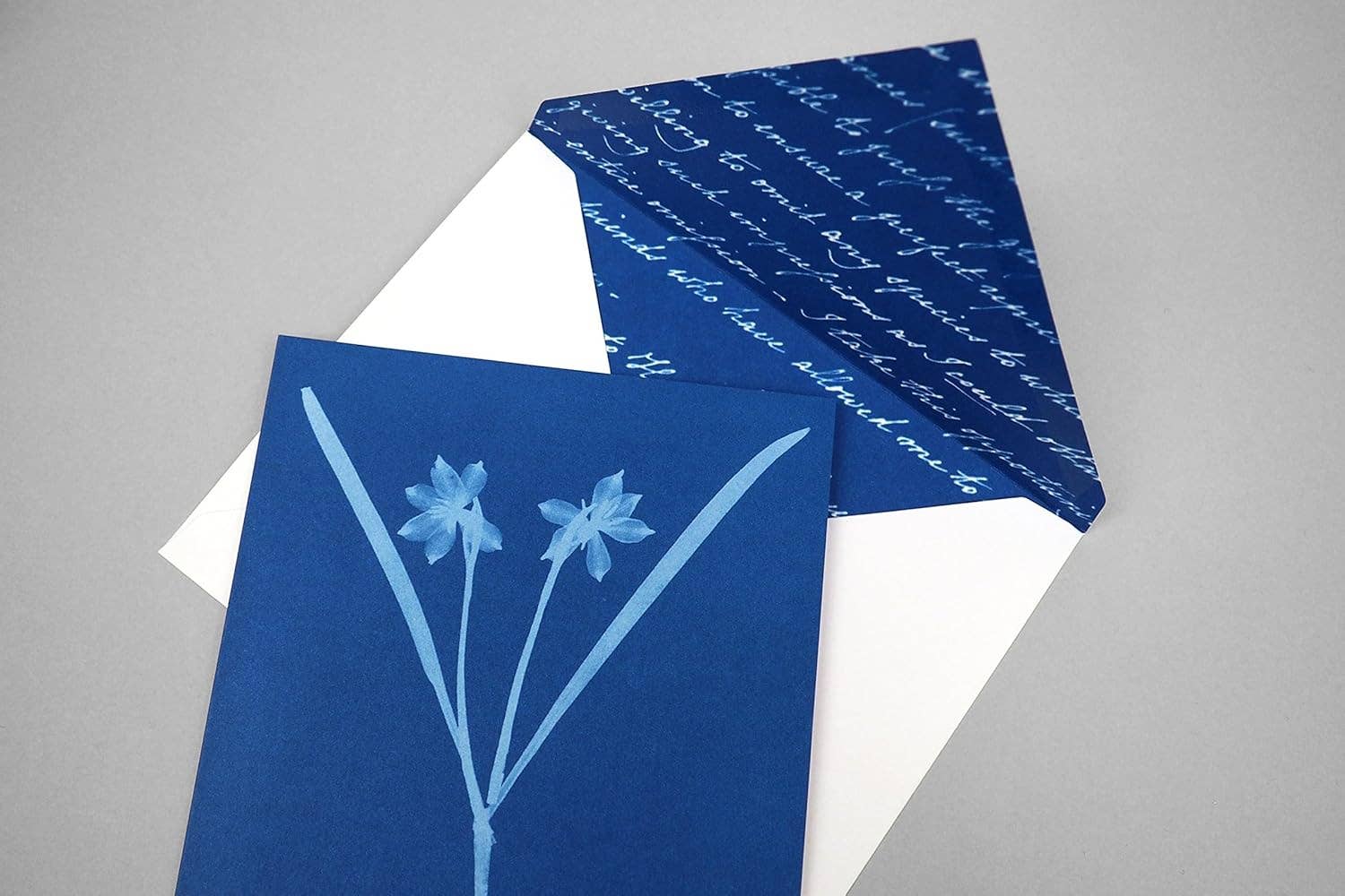 Blue greeting card with floral design on a gray background