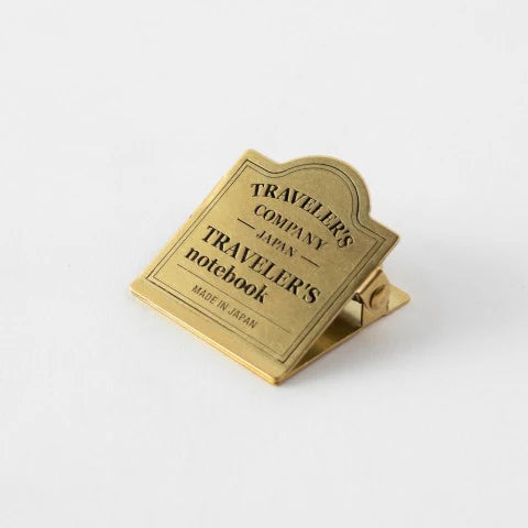 TRAVELER’S notebook Brass Clip
 branding on a white background